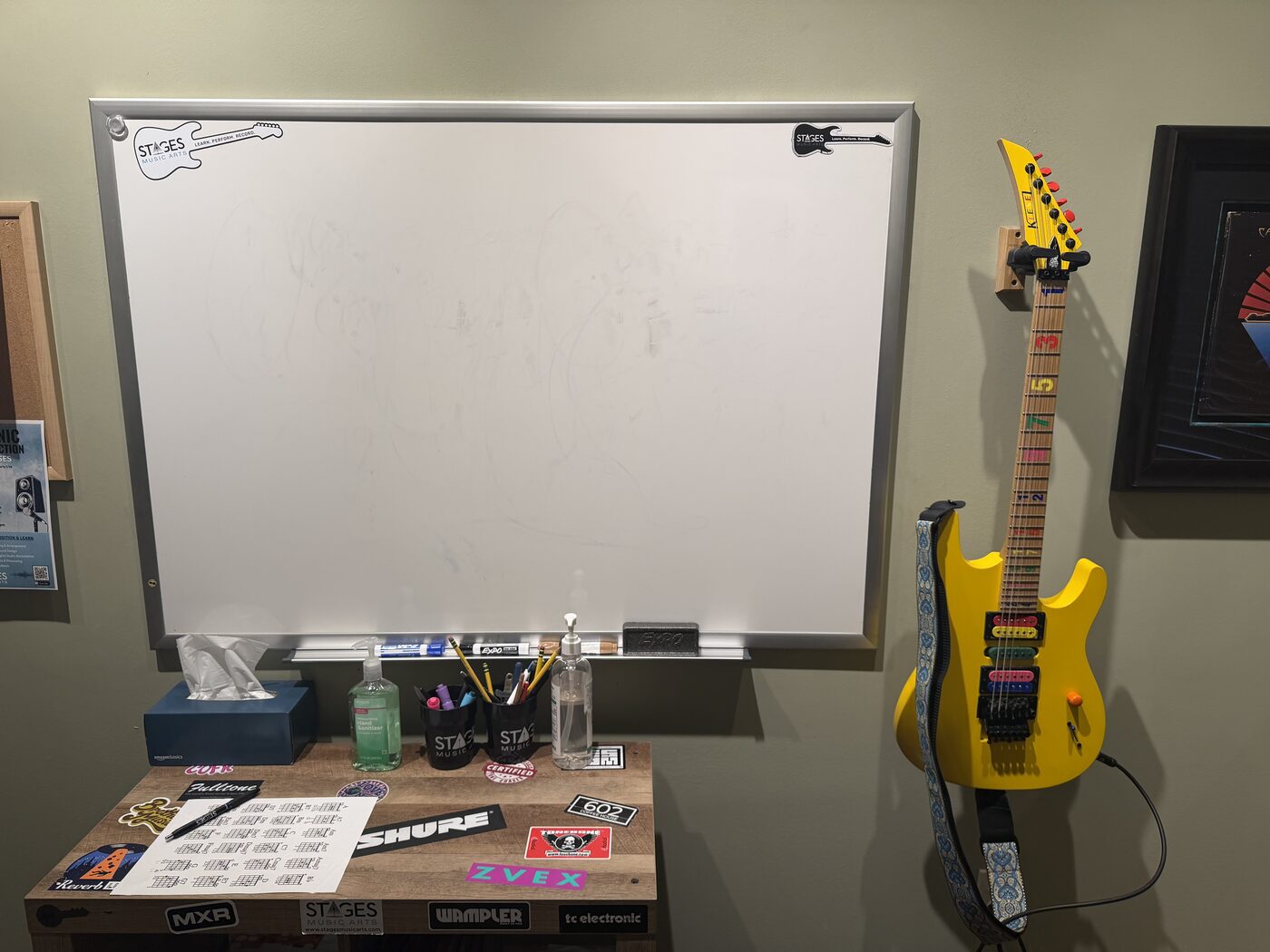 Music teaching room with whiteboard and yellow guitar